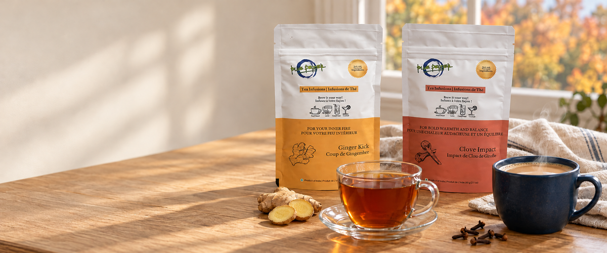 Steaming Ginger Kick tea and Clove Impact chai with Blue Pepper pouches on an autumn table