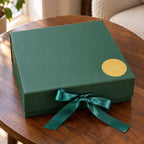 Serenity Tea Gift Set in a forest-green box closed with emerald ribbon and gold seal