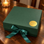 Brew Bliss Tea Gift Box in a forest-green box closed with emerald ribbon and gold seal