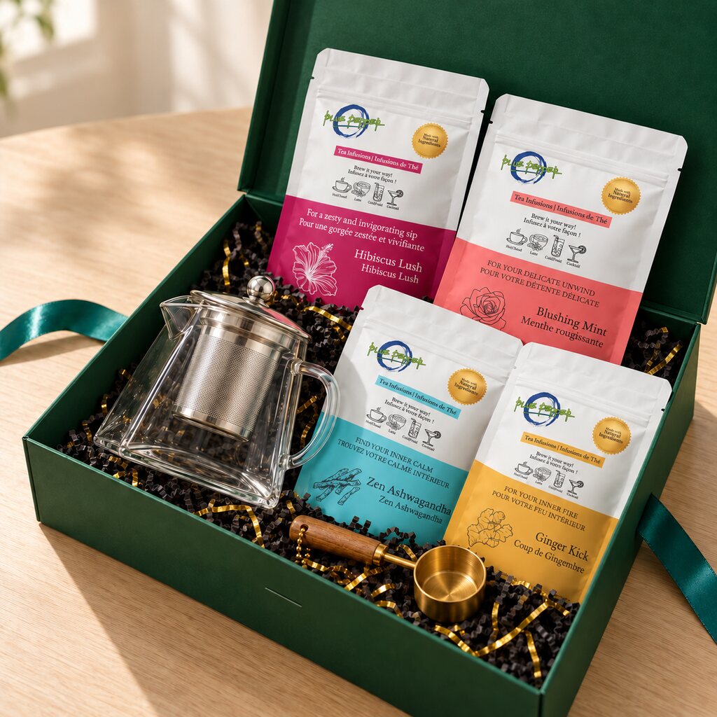 Mindful Moments Gift Box from the front right with an empty glass kettle, four tea infusions and a gold measuring spoon